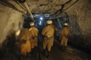 Miners are walking through the tunnel at the underground coal mine in jharkhand India