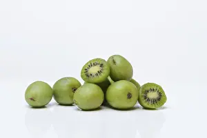 Mini kiwi, whole and halved fruit (Actinidia arguta)