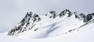Minimalist winter landscape, white snow and dark mountains on the Scalettahorn