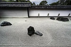 Minimalist zen garden with ornate sand patterns and rock groups