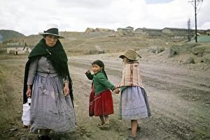 Mining in Cerro de Pasco, Peru, South America, ca. 1962 Woman with two children brings packed lunch to miner, South America