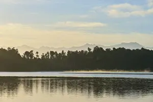 Misty lake under soft sunlight