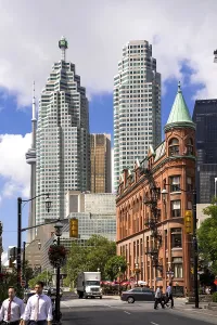 A mix of historic and modern buildings under a bright sky in Toronto