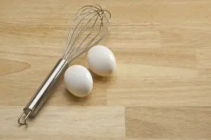 Mixer and eggs on a wooden background