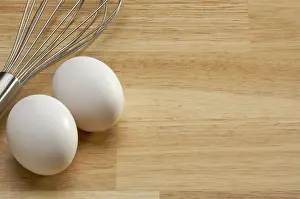 Mixer and eggs on a wooden background