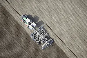 Modern agriculture, tractor working arable land in a field