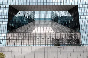 Modern glass architecture with reflective surfaces and geometric shapes in an urban environment