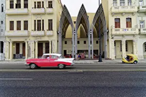 Modern-Gothic building with passing vintage car