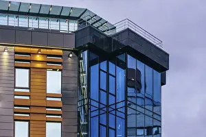 Modern high-rise office building with a glass facade at overcast