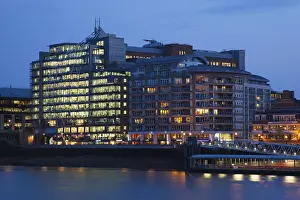 Modern office and residential buildings by the River Thames at dusk