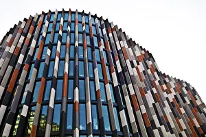 Framed Print : Modern skyscraper with a colorful facade of glass panels and abstract design