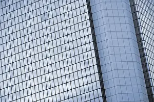 Modern skyscraper exterior with glass and reflection in daytime