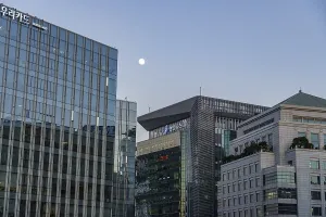 Modern skyscrapers with glass walls under a cloudless evening sky