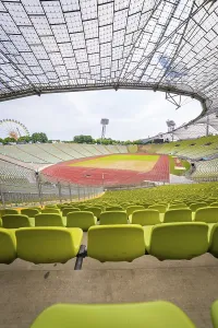 Empty modern stadium with central view of running track and striking glass architecture