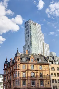 A modern tower block in Frankfurt am Main behind historic old buildings
