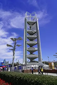 Framed Print : Modern tower under blue sky with light clouds and urban environment