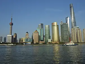 Modern urban skyline of Huangpu Jiang on the water under clear blue sky
