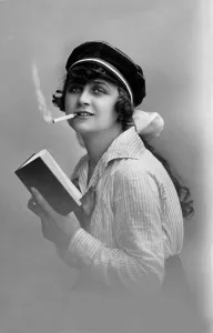 Modern youth, woman reading a book and smoking