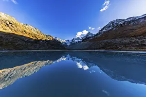 The Moiry glacier and mountain peaks are reflected in Lac de Chateaupre