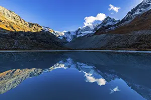 The Moiry glacier and mountain peaks are reflected in Lac de Chateaupre