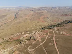 Moldo-Ashuu Pass, serpentines, car on road between yellow hills