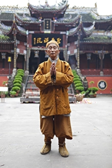 Monk, 85 years old, in front of Buddhist temple