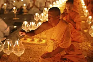 Category Buddhism Prints: Monk lights candle, meditation