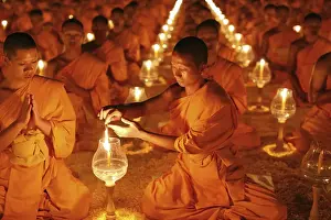 Category Buddhism Prints: Monk lights candle, meditation