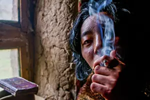 Monk smoking in a monastery, Kailash Kora