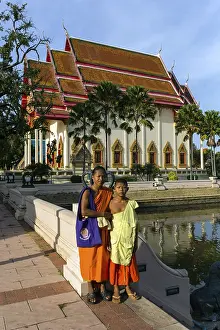 Monks, novices in front of the south facade of Wat Klang temple