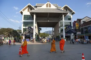 Monks walking in front of the border post between Myanmar