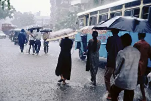 Monsoon, people walking in heavy rain