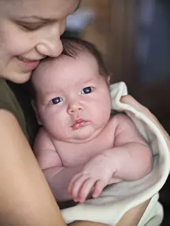 One month old baby boy in the arms of her mother