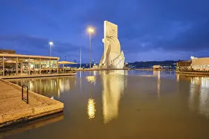 Monument to the Discoveries on bank of Tagus river in the evening twilight with reflection in pool of water