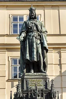 Monumental neo-Gothic statue of Emperor Charles IV from 1844 holding a sword and university charters