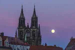 Full moon next to the cathedral towers at blue hour in Meissen