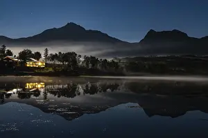 Moon and northern lights at the lake in Sandsletta