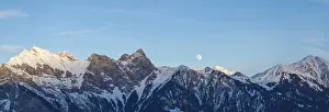Framed Print : full moon rising into the evening sky over a winter mountain landscape in the Swiss Alps