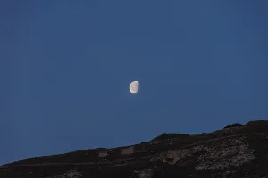 Moon over rocky cape Mesa Vouno