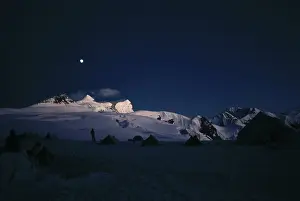 Moon over snow covered peak, campsite, himalaya