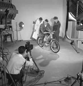 Moped 1960. A young man on a classic Crescent Sport 1139 Saxoped. The model was launched in 1959 and had a Sachs 2-stroke engine of 48cc. It was three-speed and had a racing-type windscreen