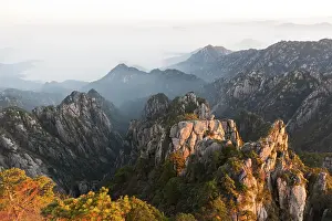 Morning atmosphere, fog, bizarre towering rocks and mountains covered with scattered trees