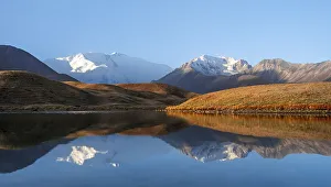 Morning atmosphere, mountains reflected in a small mountain lake