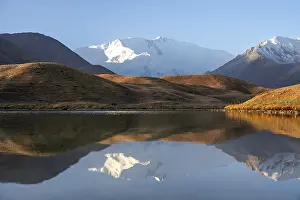 Morning atmosphere, mountains reflected in a small mountain lake