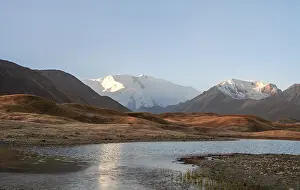Morning atmosphere, mountains reflected in a small mountain lake