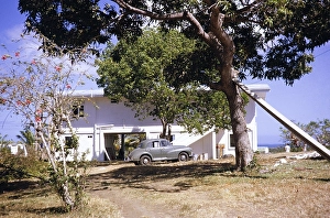 Morris Minor car parked outside coastal home, Balandra, Trinidad early 1960s
