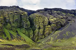 Moss-covered rock formation with entrance to the mystical lava cave