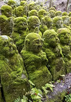 Moss-covered stone statues of rakans