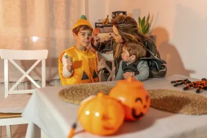 Mother applying halloween makeup on her children