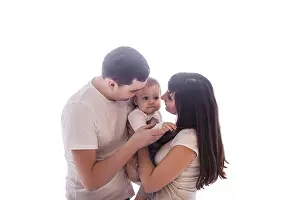 Mother and father play with her little baby girl
